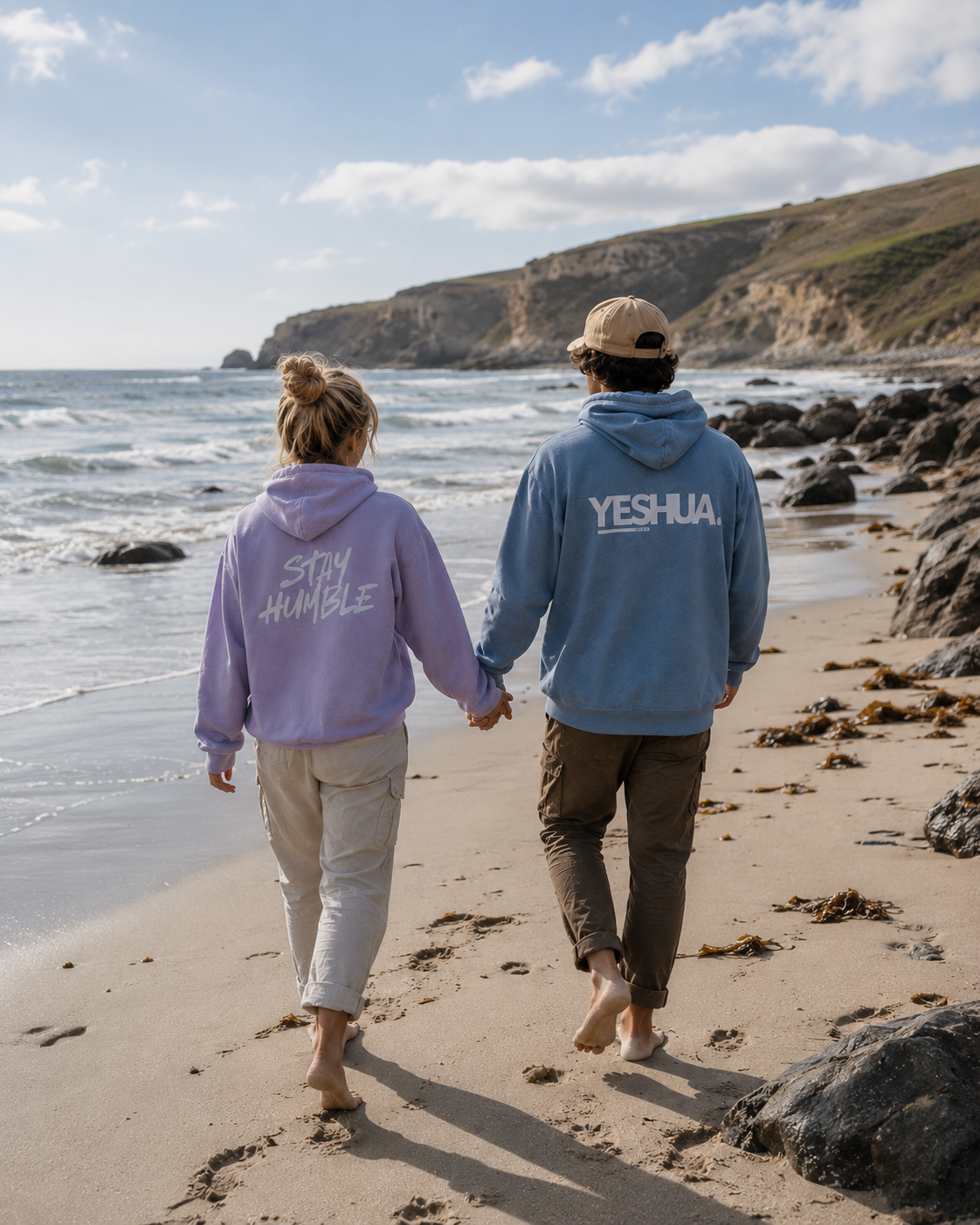 Couple walking on the beach wearing Face of Faith Stay Humble and Yeshua hoodies