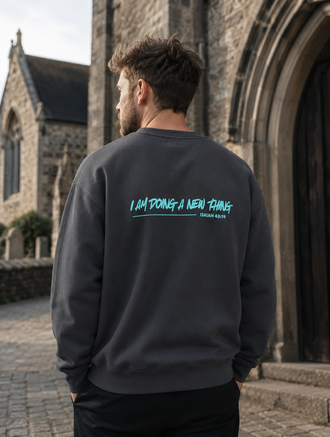 I Am Doing A New Thing Unisex Jumper Christian hoodie, church doorway lifestyle shot | Face of Faith faith apparel
